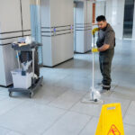 full-shot-man-cleaning-office-floor_23-2149345560